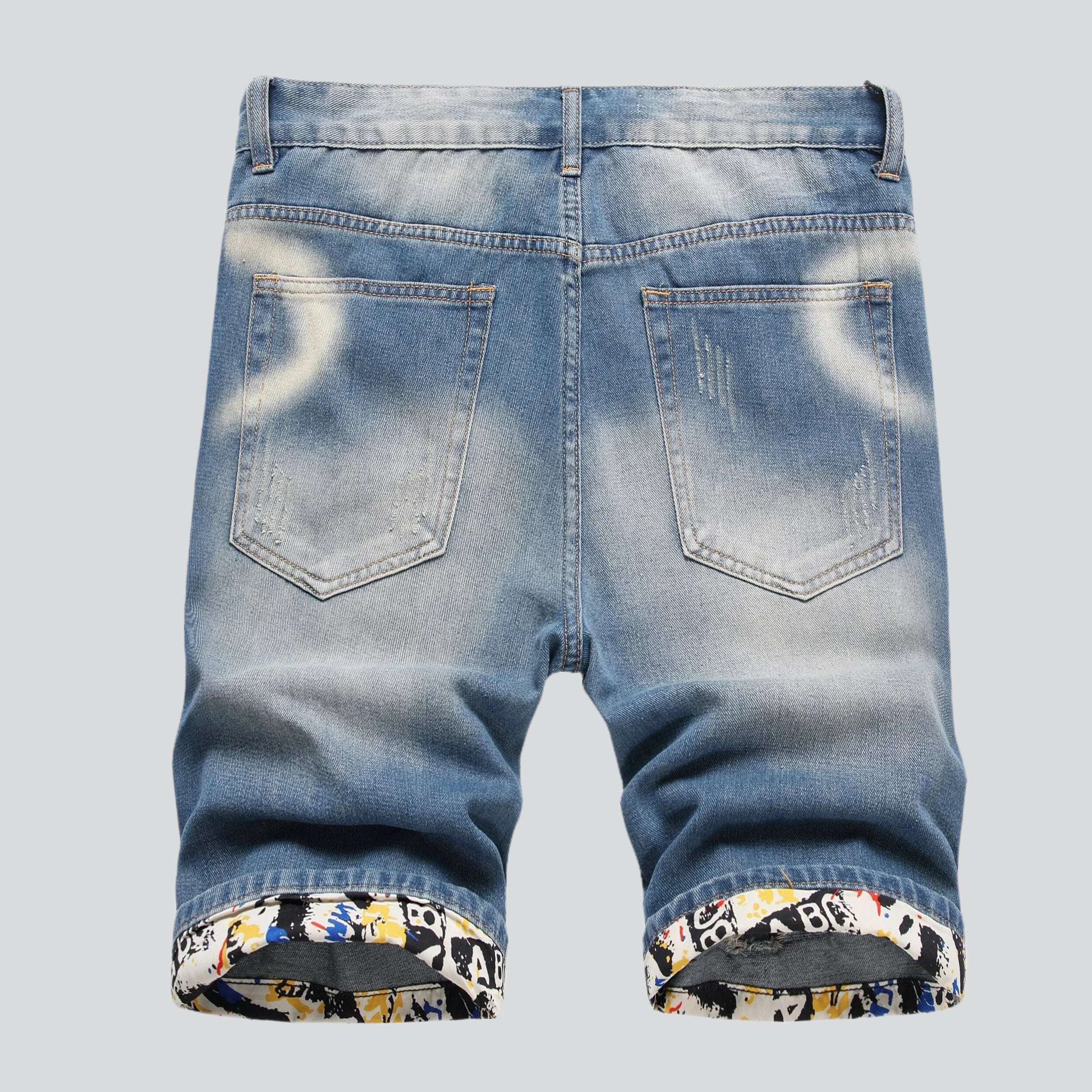 Hem embroidery ripped denim shorts